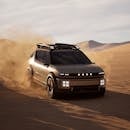 The right front view of the Hyundai INITIUM driving through the desert.